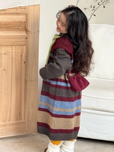 Dettaglio della trama del vestito in maglia a righe per bambini rosso e grigio