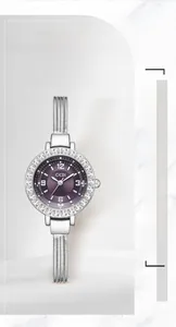 Detailed view of women's quartz watch with purple dial and silver mesh bracelet