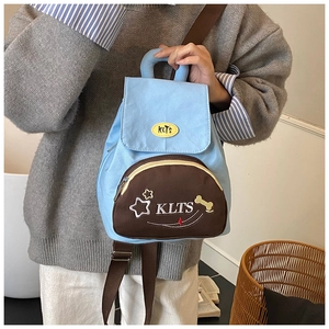 Detail of blue and brown star pattern school backpack for toddlers with adjustable straps