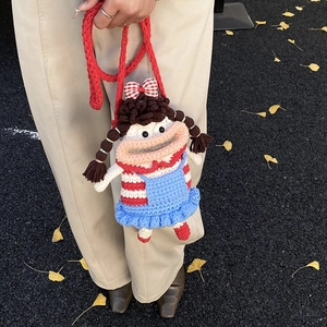 Handmade crochet doll crossbody bag for kids featuring a quirky girl design with red strap