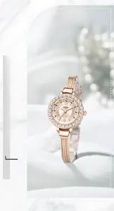 Detailed macro view of a rose gold quartz watch with a crystal-embellished bezel and mesh band