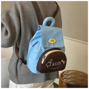 Detail of cute blue and brown kids backpack with star embroidery and adjustable straps