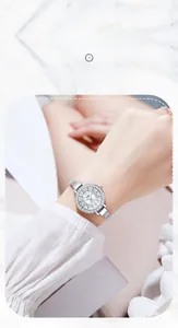 Close-up of GEDI silver quartz watch with rhinestone bezel and mesh strap on wrist