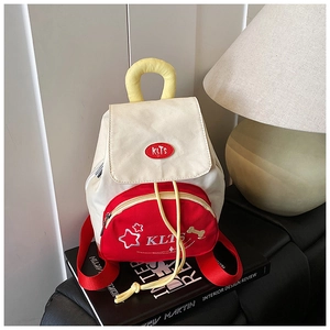 Close-up of small canvas backpack featuring star embroidery and drawstring closure