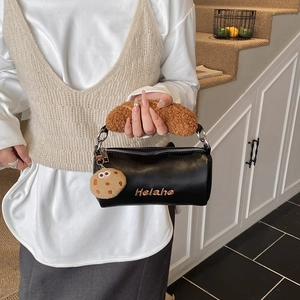Cute black cylinder shoulder bag for kids with plush handle and cookie charm accessory