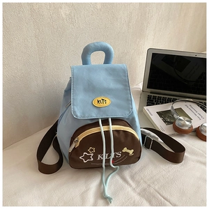 Close-up of stylish light blue canvas backpack with front pocket and star pattern details