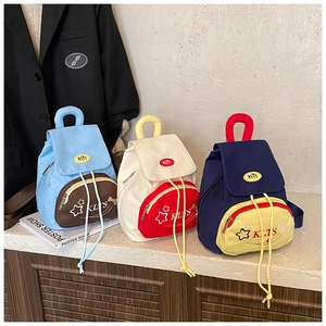 Three mini canvas backpacks for children with star patterns and drawstring flap closure