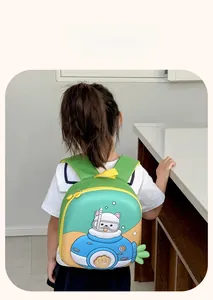 Green and yellow kids backpack with cute submarine cat illustration worn by a child