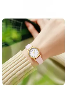 Detail of GEDI quartz watch with shell texture dial and pink leather strap on wrist