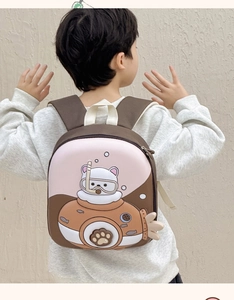 Detail of pink cartoon shell backpack with 3D submarine cat worn by toddler on back