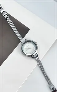 Detailed view of silver quartz bracelet watch with fringe chain and rhinestone dial