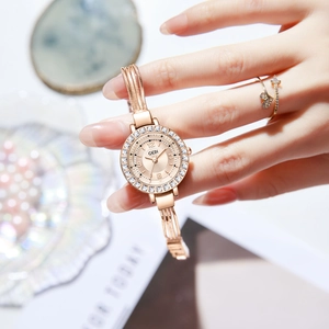 Elegant rose gold watch with crystal bezel and delicate fringe chain bracelet for women