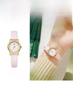 Elegant women's watch with mother of pearl dial and pink leather strap in macro detail