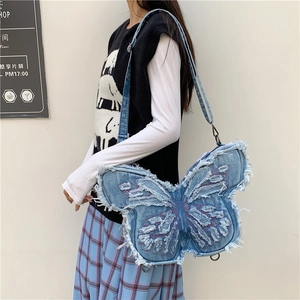 Denim butterfly crossbody bag with purple embroidery and distressed frayed edges