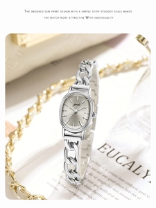 Detailed view of silver oval dial watch with sunray texture and metal chain band
