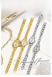Detail view of oval watches with metal chain straps in gold and silver luxury finishes