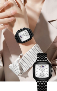 Detail of square business watch featuring moon phase dial and black steel band on wrist