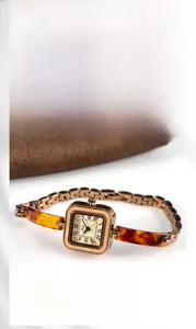 Detail of Gedi square vintage watch with amber resin and rose gold chain link strap