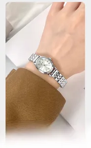 Close-up of elegant oval quartz watch for women with silver chain strap and zircon details