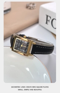 Detail of square vintage watch with black dial and leather strap on white plate