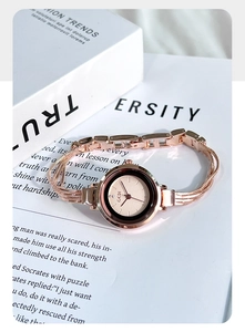 Macro shot of rose gold quartz watch with minimalist dial and multi-strand chain strap