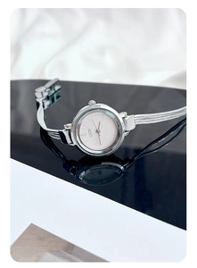 Close-up of GEDI silver mesh strap watch with a white dial and reflective finish