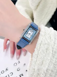 Close-up of GEDI vintage square watch with blue dial and leather strap on woman wrist