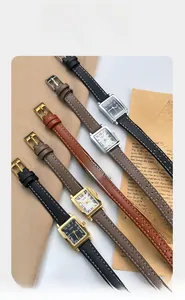Macro shot of vintage square quartz watches with Roman numerals and leather straps