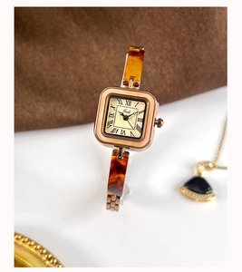 Macro detail of Gedi vintage square watch with amber resin strap and champagne gold dial