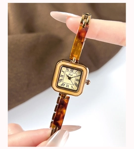 Detail of Gedi square watch with Roman numerals and tortoiseshell resin link strap