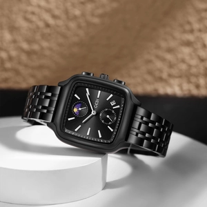 GEDI black square business watch with steel band and date window on a geometric base