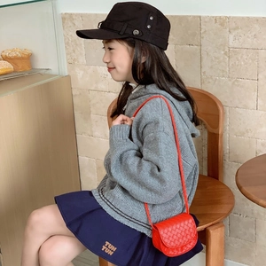 Red quilted mini shoulder bag for kids with woven texture and round crossbody strap