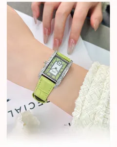 Macro detail of the GEDI vintage square watch with emerald green leather strap and diamonds