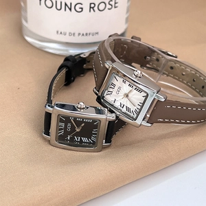 Elegant GEDI retro square quartz watch set with leather straps on a beige satin backdrop