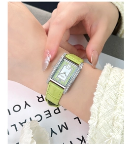 Detail of GEDI rectangular watch with green dial, diamond bezel, and leather strap