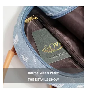 Detail view of denim backpack interior with zipper pocket and fabric lining
