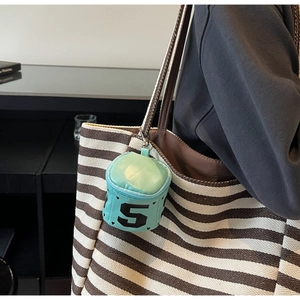 Mint green cylinder coin purse charm with heart and number five on a tote bag