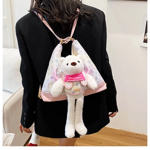 Detail of cute teddy bear plush shoulder bag with pink leather straps on model
