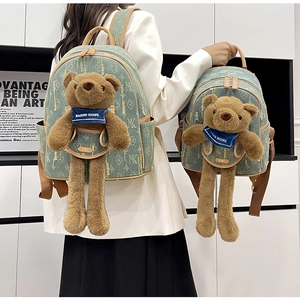 Detailed comparison of large and mini green floral backpacks with plush bear accessories