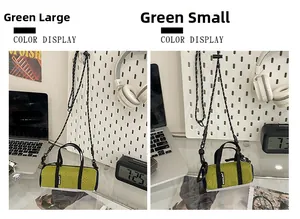 Size comparison of large and small green nylon cylinder bags on a minimalist desk setup