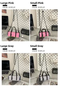 Pink and grey nylon cylinder crossbody bags in large and small sizes on a desk