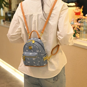Blue denim canvas backpack with white bear prints and brown leather trim for women