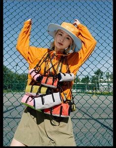 Mini cylindrical running crossbody bag in vibrant colors for outdoor sports use