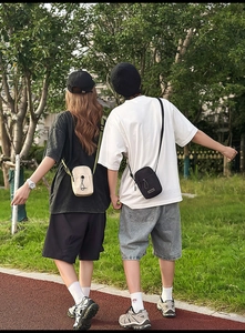Outdoor leisure crossbody phone bags in cream and black with drawstring details