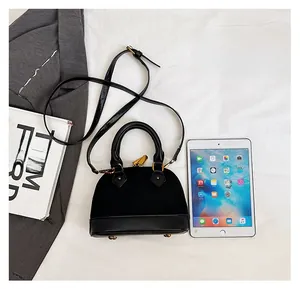Mini sac coquille matelassé noir montrant la capacité par rapport à un iPad