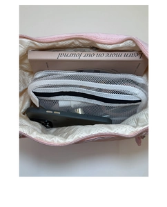 Internal view of pink canvas bag showing mesh pocket, notebook and phone for capacity