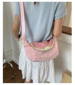 Pink guava shoulder bag with fruit slice embroidery and wide fabric strap in detail