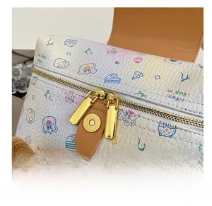 Close-up of white lychee leather backpack with cartoon prints and golden zipper detail