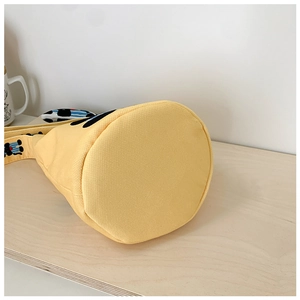 Detail of round bottom and reinforced stitching on yellow canvas kids bucket bag