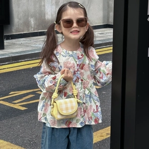 Chic kids plaid mini crossbody bag paired with floral shirt and stylish denim outfit